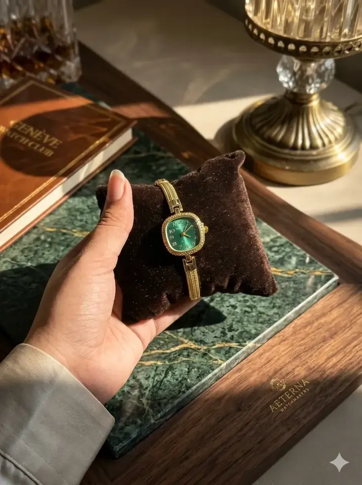 Green dial watch on a marble tray