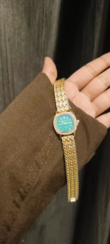 Turquoise dial watch on a wrist